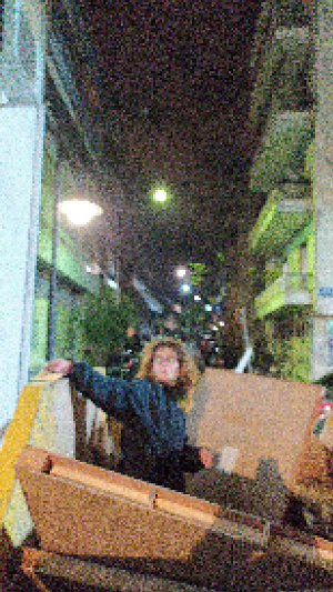 image of person peeking out from trash bin